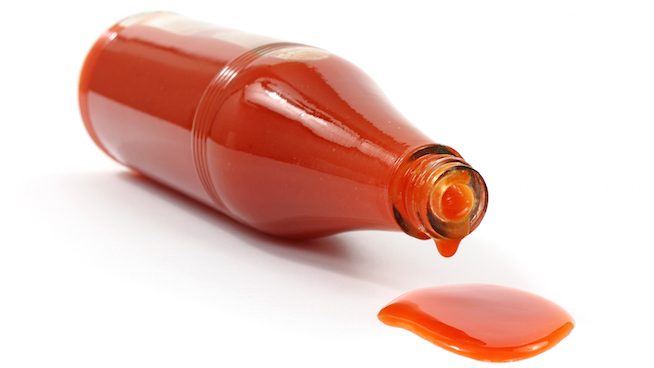 Hot sauce spilling from bottle